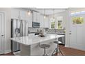 Modern kitchen with white cabinets, stainless steel appliances, and a large quartz island at Tbd Channel Drop Dr # 94, Clayton, NC 27520