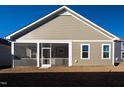 Rear view of house showing screened porch and yard at 108 Swain St, Clayton, NC 27527
