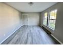 Bright and airy living room with grey vinyl plank flooring and neutral walls at 1304 Queen Ann St, Burlington, NC 27217