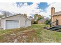 Detached single car garage with gray door and light beige siding at 1054 George Bason Rd, Graham, NC 27253