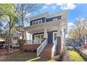 Two-story home with brick and blue siding, front porch, and a lovely lawn at 2408 Everett Ave, Raleigh, NC 27607