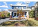 Two-story blue house with brick accents, front porch, and a charming facade at 2408 Everett Ave, Raleigh, NC 27607