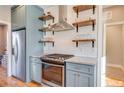 Modern kitchen with stainless steel appliances and shaker-style cabinets at 255 Baptist Grove Rd, Fuquay Varina, NC 27526