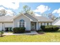 Ranch style home with a two-car garage and well-maintained lawn at 60 Rock Harbor Ln, Spring Lake, NC 28390