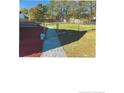 Large backyard with a grassy area and a gravel pathway at 15 Montana Ln, Spring Lake, NC 28390