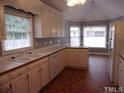 Eat-in kitchen with white cabinets and island at 1503 Fairview St, Dunn, NC 28334