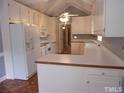 Bright kitchen with white cabinets and appliances at 1503 Fairview St, Dunn, NC 28334