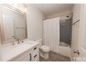 Modern bathroom with gray tile and white vanity at 1309 S 11Th St, Lillington, NC 27546