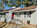 Ranch style home with red front door at 1210 Guy Ave, Dunn, NC 28334