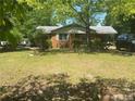 Brick ranch house with a large yard at 1058 Sanders Rd, Sanford, NC 27332