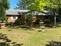 Brick ranch house with a landscaped yard at 1058 Sanders Rd, Sanford, NC 27332