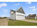Two-story home showcasing a large white two-car garage and gray siding at 53 Hillwood Dr, Sanford, NC 27332