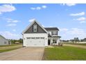 Two-story house with gray and white siding, two-car garage, and a landscaped lawn at 53 Hillwood Dr, Sanford, NC 27332