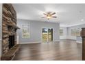 Spacious living room with stone fireplace and sliding glass doors at 109 Hillwood Dr, Sanford, NC 27332