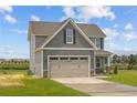 Gray siding two-story house with a two-car garage and landscaping at 76 Hillwood Dr, Sanford, NC 27332