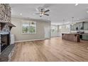 Open floor plan with kitchen, living area, and stone fireplace at 147 Hillwood Dr, Sanford, NC 27332
