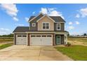 Two-story house with gray and beige siding, a three-car garage, and a landscaped yard at 188 Hillwood Dr, Sanford, NC 27332