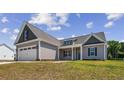 Single-story house with a two-car garage and a grassy yard at 50 Oleander Ln, Sanford, NC 27332