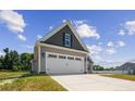 Two-car garage with white doors and gray siding at 50 Oleander Ln, Sanford, NC 27332