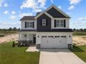 Two-story house with gray and white siding, and a two-car garage at 114 Hillwood Dr, Sanford, NC 27332