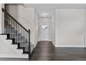 Elegant staircase with dark metal railing and hardwood flooring at 114 Hillwood Dr, Sanford, NC 27332