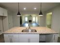 Kitchen with island, granite countertops, and white cabinets at 117 Godwin Ct, Sanford, NC 27330