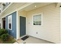 Front exterior of townhome with blue and beige siding at 100 Chandler Ct, Sanford, NC 27330