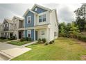 Two-story townhome with blue and beige siding, well-maintained lawn at 100 Chandler Ct, Sanford, NC 27330