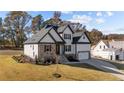 Two-story house with white siding, stone accents, and a two-car garage at 148 Hook Dr # 7, Fuquay Varina, NC 27526