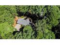 Bird's-eye view of a house nestled in a lush, wooded area at 3126 Sand Wedge, Sanford, NC 27332