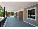 Covered front porch with gray decking and black railing at 6663 Nc 56 Hwy, Franklinton, NC 27525