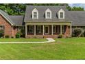 Brick house with a large front porch and a spacious yard at 951 Weeks Rd, Dunn, NC 28334