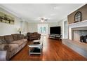 Living room features hardwood floors, a fireplace, and access to backyard at 951 Weeks Rd, Dunn, NC 28334