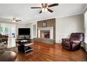 Spacious living room with hardwood floors, a fireplace, and plenty of natural light at 951 Weeks Rd, Dunn, NC 28334