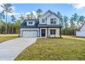 Two story farmhouse with a white exterior and large yard at 6913 Old Jefferson Davis Hwy, Cameron, NC 28326