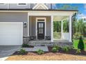 Covered front porch with stone accents and black front door at 4455 Old Us Hwy 421, Lillington, NC 27546