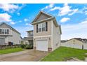 Tan two-story house with black window frames, a two-car garage, and a well-maintained lawn at 72 New London Hbr, Cameron, NC 28326