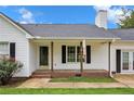 Front porch of a white house with brick base at 585 Bill Avery Rd, Coats, NC 27521