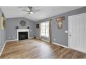 Living room with fireplace, wood floors, and gray walls at 585 Bill Avery Rd, Coats, NC 27521