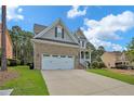 Two-story home with brick and siding exterior, double garage, and front porch at 738 N Micahs Way, Spring Lake, NC 28390