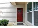 Front entrance with a red door and a large window at 1365 Micahs Way, Spring Lake, NC 28390