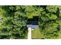 House nestled in a wooded lot, aerial view at 2017 Fairview Ln, Sanford, NC 27330