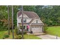 Two-story house with stone accents and a two-car garage at 32 Waterside Cir, Spring Lake, NC 28390