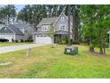 Two-story house with gray siding, two-car garage, and a well-manicured lawn at 165 Timber Skip Dr, Spring Lake, NC 28390