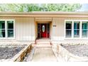 Inviting ranch home exterior with a red front door and stone pathway at 1634 Stonegate N, Sanford, NC 27332