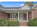 Brick home with covered front porch and landscaping at 757 Stone Cross Dr, Spring Lake, NC 28390