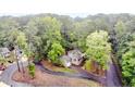 Aerial view of home with a circular driveway and lush trees at 1056 Windrace Trl, Sanford, NC 27332