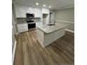 Modern kitchen island with granite countertops and white cabinets at 910 West St, Smithfield, NC 27577