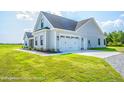 Gray siding house with a two-car garage and nicely landscaped lawn at Tbd 1 Cedar Lane Rd, Sanford, NC 27332