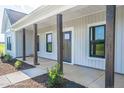 House exterior features gray siding, a front porch, and a two-car garage at Tbd 1 Cedar Lane Rd, Sanford, NC 27332